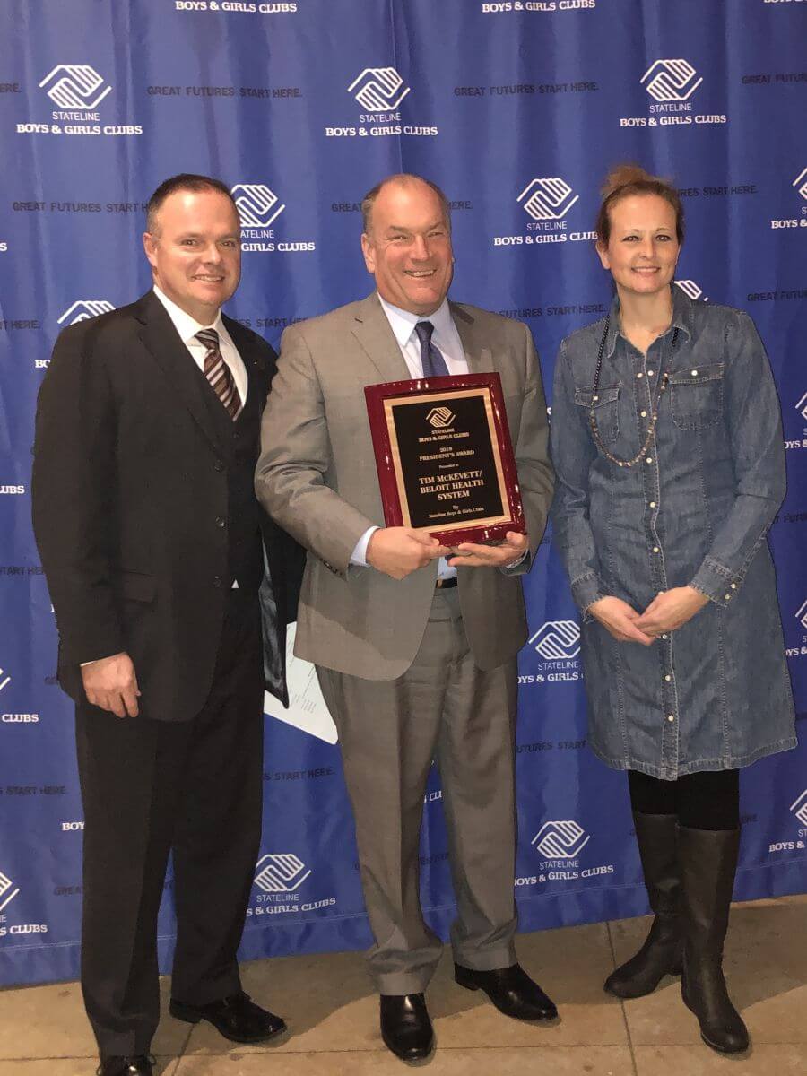 Group picture with Man holding an award